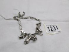 An unusual silver bracelet with 8 charms, approximately 26.7 grams.