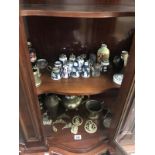 2 shelves of pottery and brassware including Wedgwood container, brass vases etc.