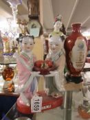 A Chinese advertising figure and a Chinese figure group.