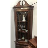 A mahogany finished astragal glazed corner cupboard