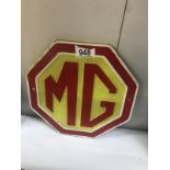 A cast iron 'MG' logo sign
