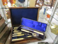 A cased part cutlery set and a cased pair of fish servers.