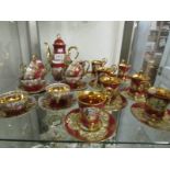 A 16 piece Josef Kuba Alt Wein coffee set and a 14 piece Josef Kuba Millson coffee set.