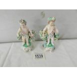 A pair of 19th century cherub figurines with flowers, 12 cm tall.