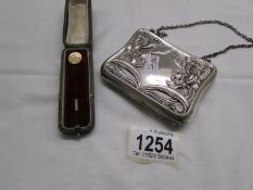 An ornate German silver 'Art Nouveau' purse and a 19th century yellow metal stick pin in original