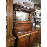 A mahogany mirror backed sideboard.