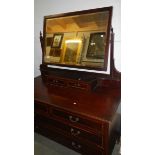 An Edwardian cross banded dressing table, mirror slightly a/f).