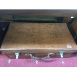 A large vintage leather suitcase