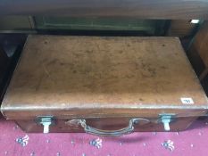 A large vintage leather suitcase