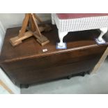 A dark oak gateleg table with barley twist legs