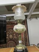 An oil lamp with glass font and later shade.