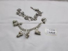 2 silver charm bracelets with charms including silver.
