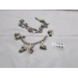 2 silver charm bracelets with charms including silver.