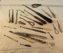 A tray of assorted button hooks including some silver together with German silver glove stretchers.