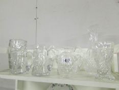 3 good quality cut glass vases and 5 good quality cut glass jugs.