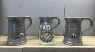 3 armorial metal tankards and a glass example.