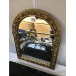 A gilt framed arch top mirror