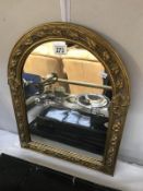 A gilt framed arch top mirror