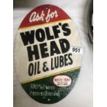 A cast iron Wolf's Head oil & lubes advertising sign