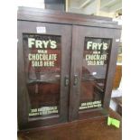 A cabinet with painted Frys sign to glass.