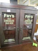 A cabinet with painted Frys sign to glass.