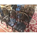 A set of 6 wheel back dining chairs