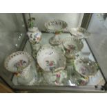 7 items of Dresden china with floral encrusted decoration.