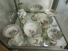 7 items of Dresden china with floral encrusted decoration.