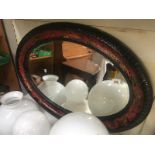 A large oval bevel edged mirror