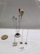 A silver hat pin stand, Chester 1907/07, a/f with hat pins including 2 insect examples.
