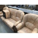 A salmon pink leather 3 piece suite and foot stool