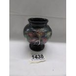 A small Moorcroft posy vase with floral design, approximately 9cm (3.