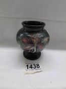 A small Moorcroft posy vase with floral design, approximately 9cm (3.