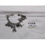 A charm bracelet with 12 silver charms and silver padlock.
