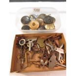 A quantity of old clock keys and pendulums in 2 trays.