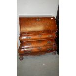 A walnut bombe front bureau.