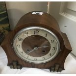 An Edwardian oak mantle clock