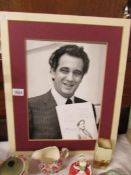A signed photograph with notes and start of music by Placido Domingo.