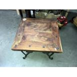 A small square coffee tabl with wrought iron wire legs & rivets