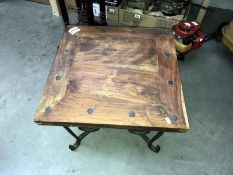 A small square coffee tabl with wrought iron wire legs & rivets