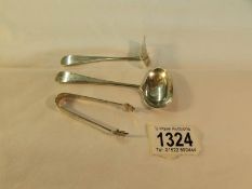 A silver spoon, a silver pusher and small silver sugar nips. 44 grams.