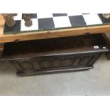 A dark oak blanket box with drape front