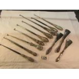 9 silver handled button hooks and 3 silver handled shoe horns.