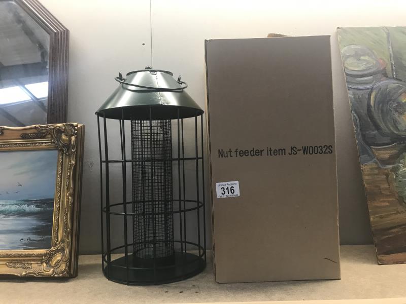 A boxed metal bird feeder
