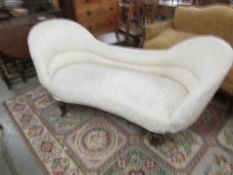 A cream double ended chaise longue.