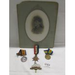 3 WW1 medals dedicated to Pte T. Burrows, Lincolnshire Regiment, a cap badge and a photograph.