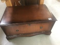 A mahogany finished television stand with drop down front and slide out shelf