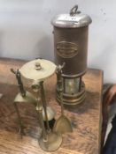 A miners lamp and a small brass fire companion set