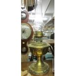 A brass oil lamp with chimney.