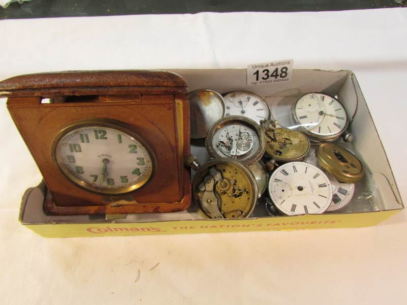 A tray of watch spares including travel clock.